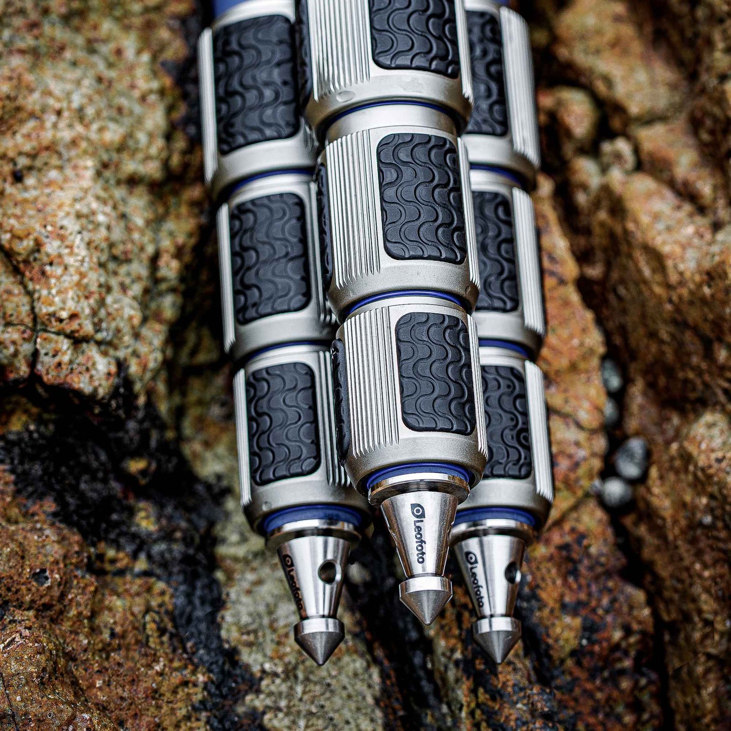 Leofoto LP-324C Poseidon Series water resistant carbon fiber tripod legs with textured grips on rocky surface