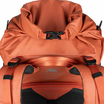 Summit Creative camera backpack in orange with a roll-top closure and adjustable straps for easy access